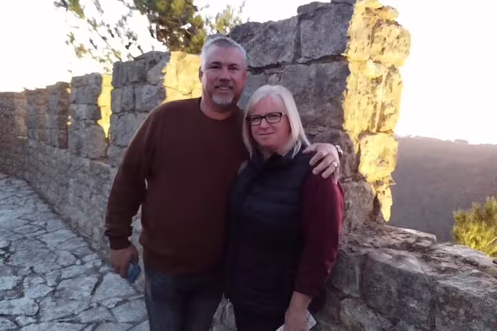 Couple enjoying scenic views during a private tiles painting workshop and wine tasting tour in historic Sesimbra.