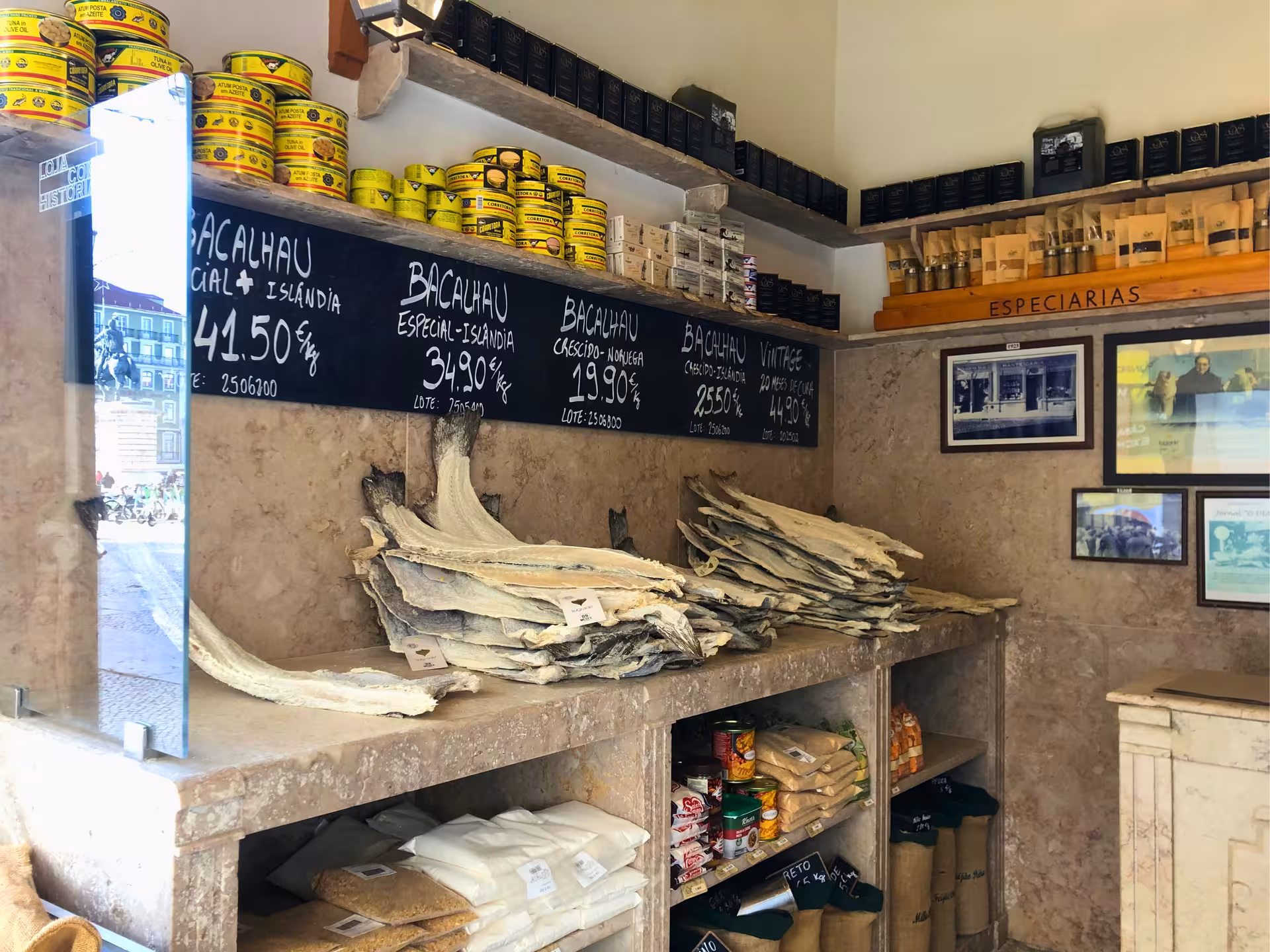 Traditional Lisbon bacalhau shop with dried cod stacks and chalkboard prices on Old Shops tour
