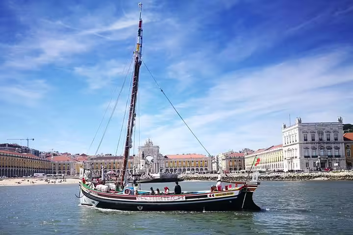 Experience Lisbon's charm with a traditional boat cruise passing the historic Praça do Comércio waterfront.