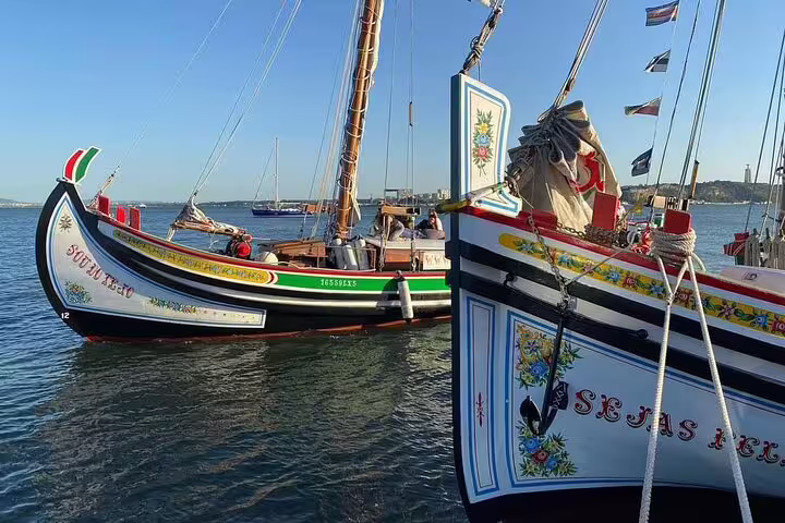 Two colorful traditional boats docked in Lisbon, highlighting intricate designs and ready for an express cruise adventure.