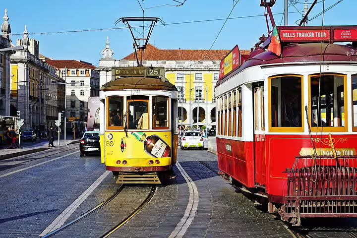Historic Lisbon trams in vibrant colors at a city square, perfect for a customizable day trip to Tomar from Lisbon.