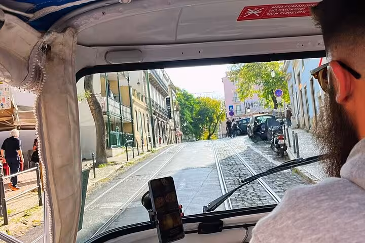 View from tuk tuk along Lisbon tram tracks in the historic center during a 3-hour private sightseeing tour