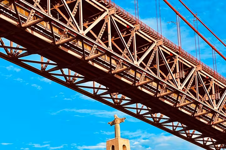 25 de Abril Bridge over Cristo Rei viewpoint, iconic stop on Lisbon tuk-tuk tour before sunset sailing