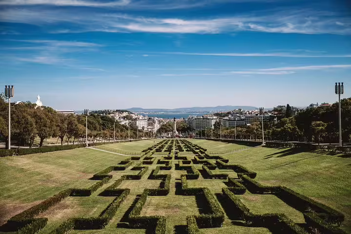 Discover Eduardo VII Park's iconic geometric hedges with panoramic views on a Lisbon Tuk Tuk tour.