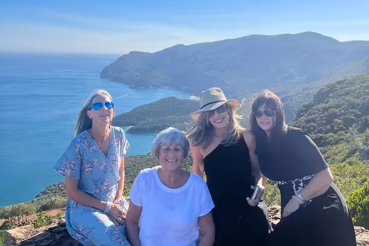 Friends enjoying a scenic Lisbon wine tour viewpoint above the Atlantic, paired with premium wine & food tastings