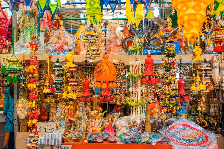 Colorful market stall in Little India, Singapore, showcasing vibrant cultural artifacts and traditional decorations.