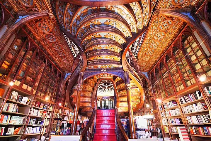 Explore the stunning architectural beauty of Livraria Lello in Porto on a private tour from Lisbon, featuring ornate woodwork and historic charm.