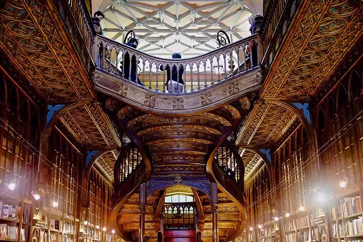 Historic Livraria Lello in Porto, featuring ornate wooden staircases and intricate ceilings, a highlight of the Lisboa to Porto private tour.