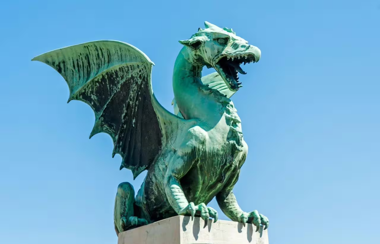 Ljubljana Dragon Bridge statue under blue sky, highlight stop on Green Escapes Istria and Slovenia self-drive