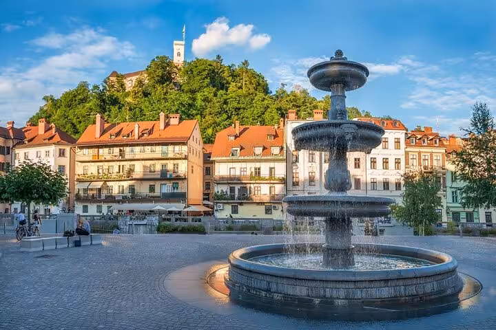 Ljubljana Old Town fountain and castle hill view on a private day tour from Vienna to Slovenia