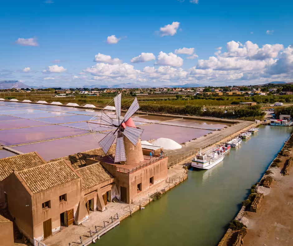 Historic windmill and colorful saltpans of Lo Stagnone lagoon near Marsala, seen on the private Segesta and Mothia tour from Palermo