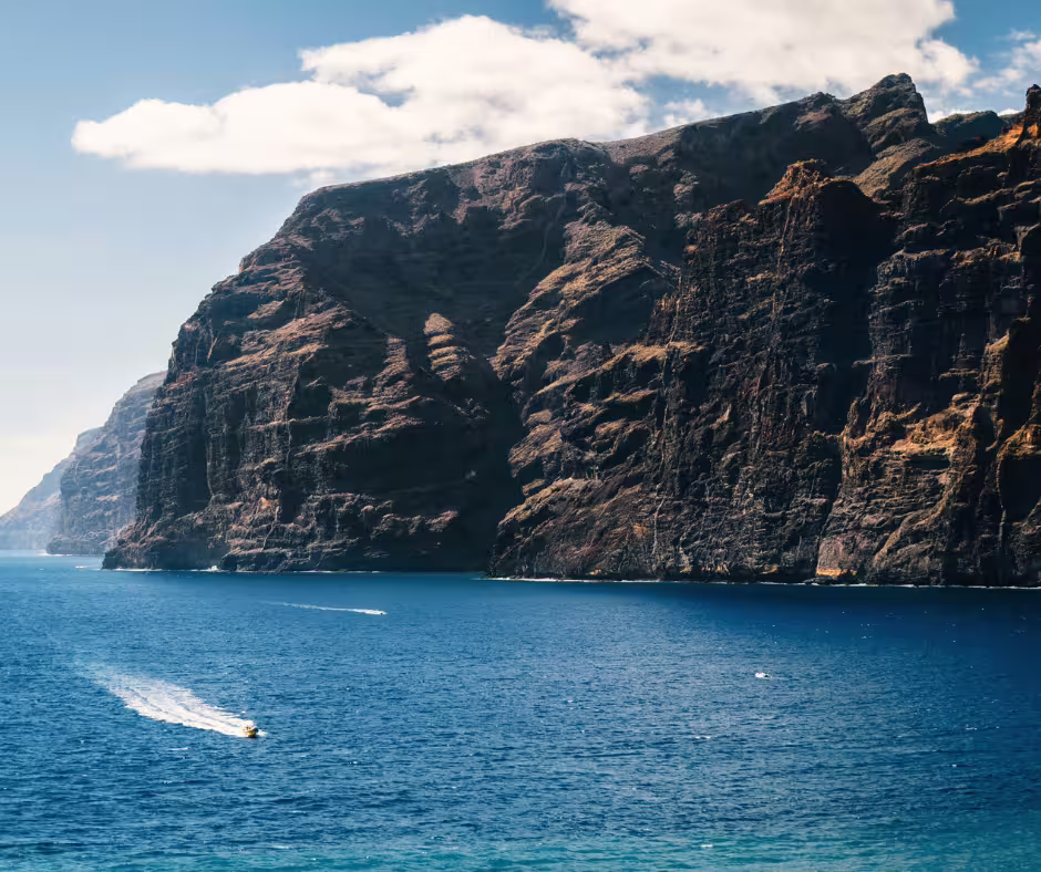 Majestic cliffs of Los Gigantes rising above the blue ocean, perfect for a private island excursion.