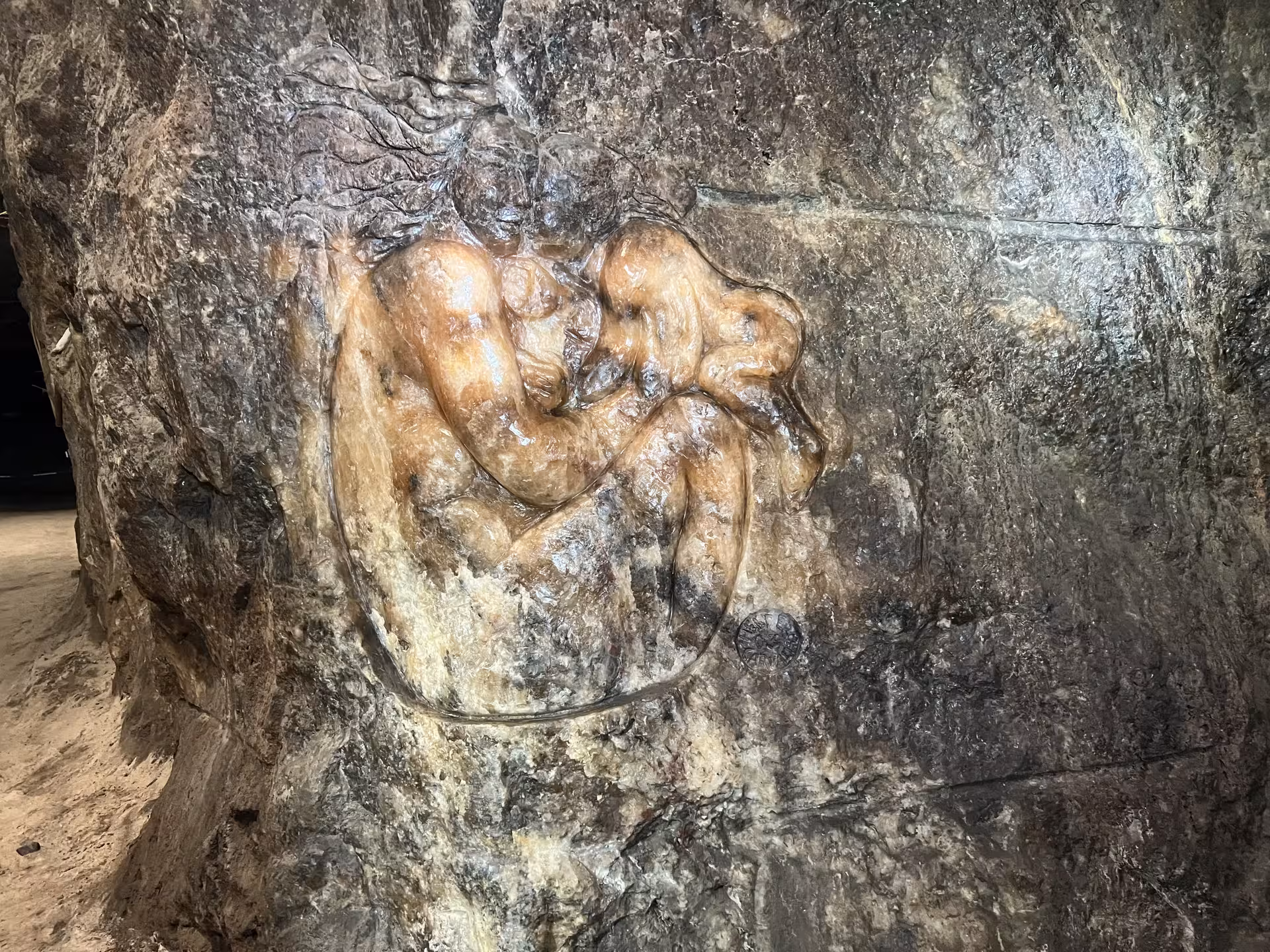 Intricate sculpture carved into the rocky walls of Loulé rocksalt mine, showcasing local artistry.