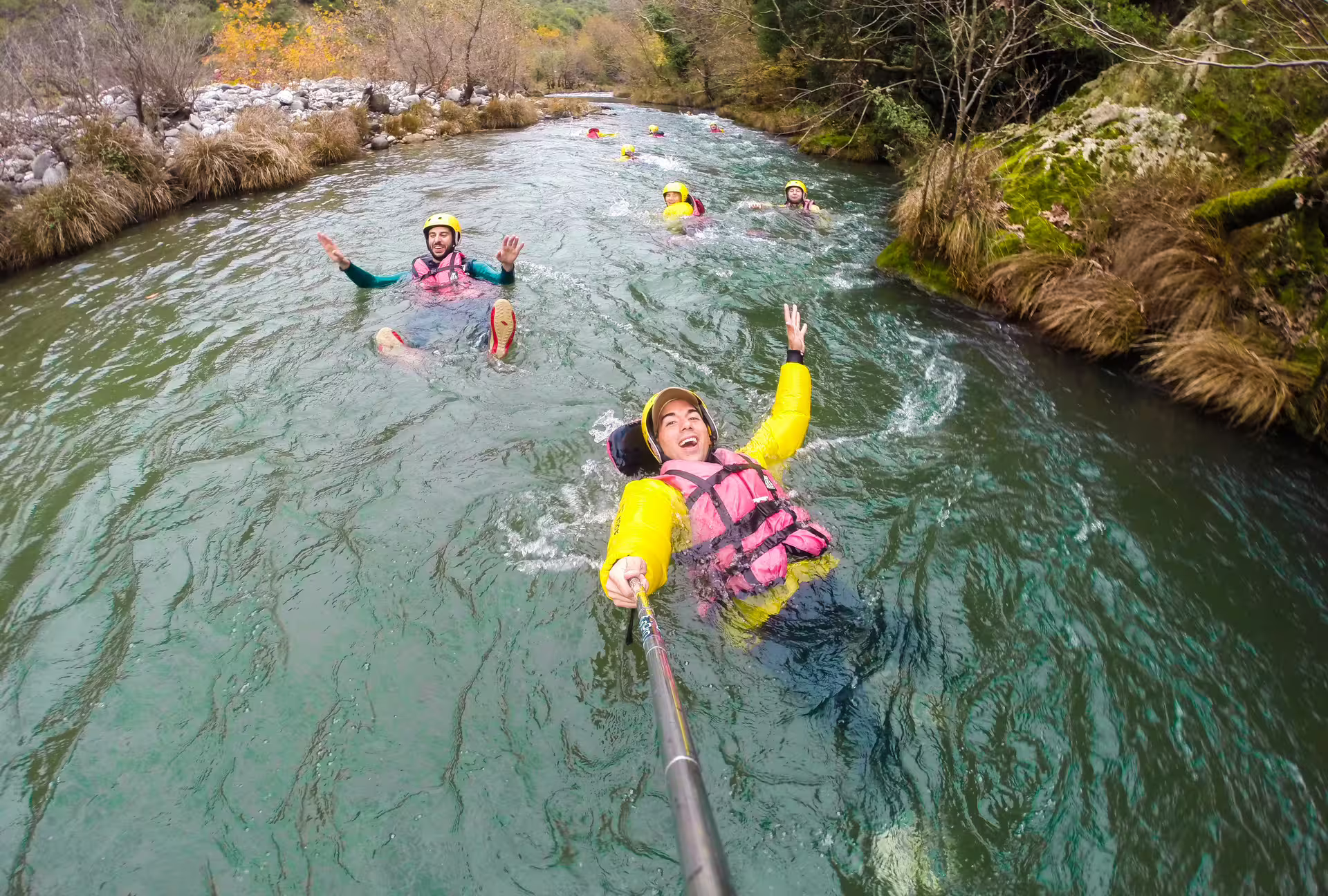 Group river floating with helmets and life jackets during Lousios and Alfeios rafting adventure in Arcadia Greece