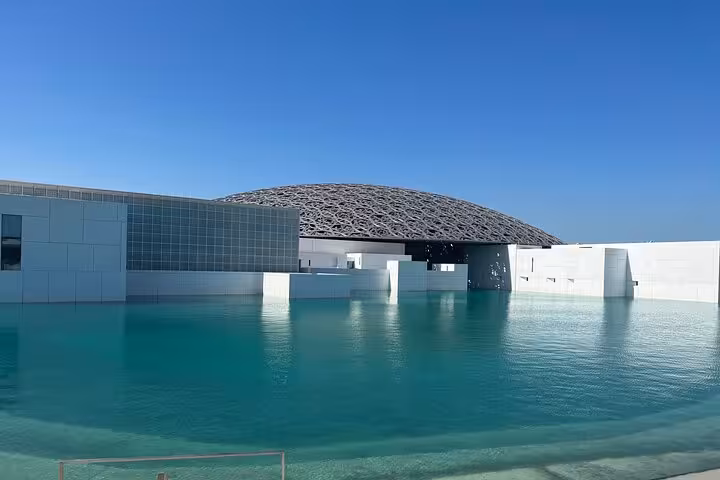 Louvre Abu Dhabi dome and turquoise lagoon view on Abu Dhabi city tour with Etihad Towers 300M restaurant