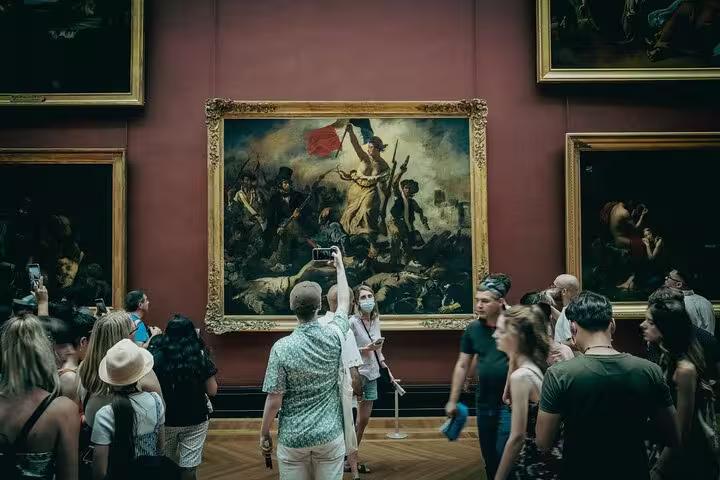 Visitors admire Delacroix’s Liberty Leading the People on a private guided Louvre Museum tour in Paris