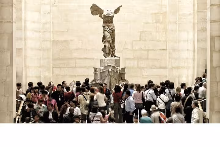 Crowds viewing Winged Victory of Samothrace at the Louvre Museum, entry with Full Day Paris City Pass 50 museums