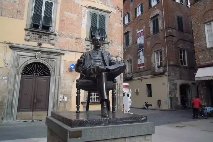 Bronze statue in a quiet Lucca square, a cultural stop on the Pisa & Lucca private tour with wine-tasting from La Spezia