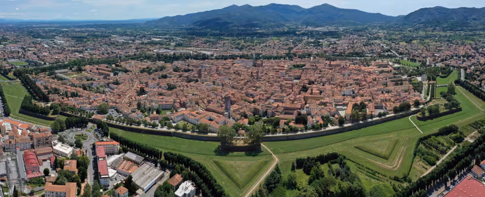 Panoramic aerial view of Lucca's historic city walls and landscape, a highlight of the Pisa and Lucca day trip from Florence.