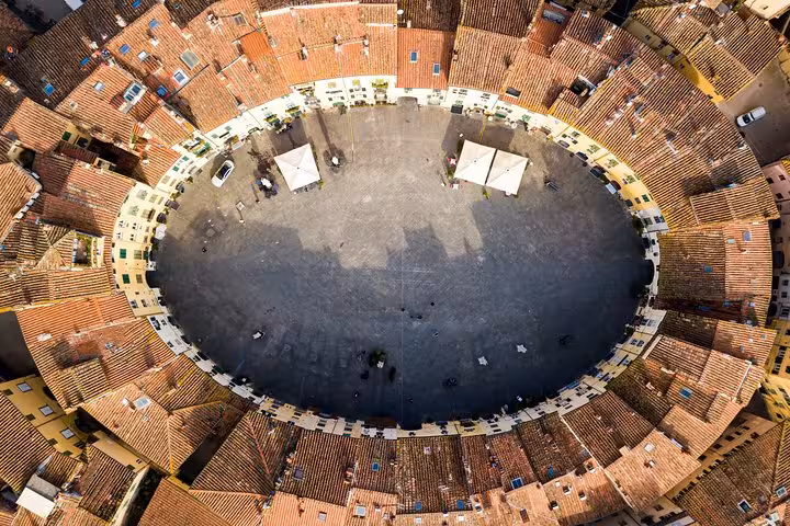 Aerial view of Lucca's iconic oval Piazza dell'Anfiteatro, showcasing its unique architecture on a Livorno shore tour.
