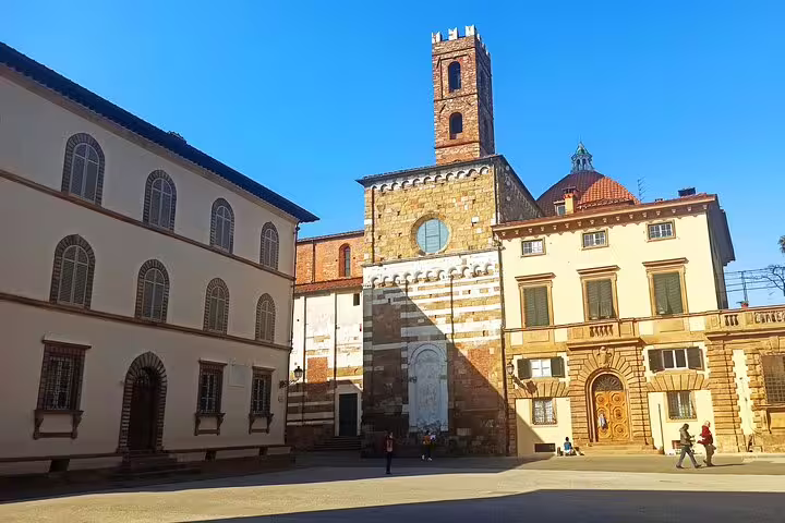 Sunny piazza in Lucca with historic church tower and Renaissance palazzi visited on private Pisa and Lucca day trip