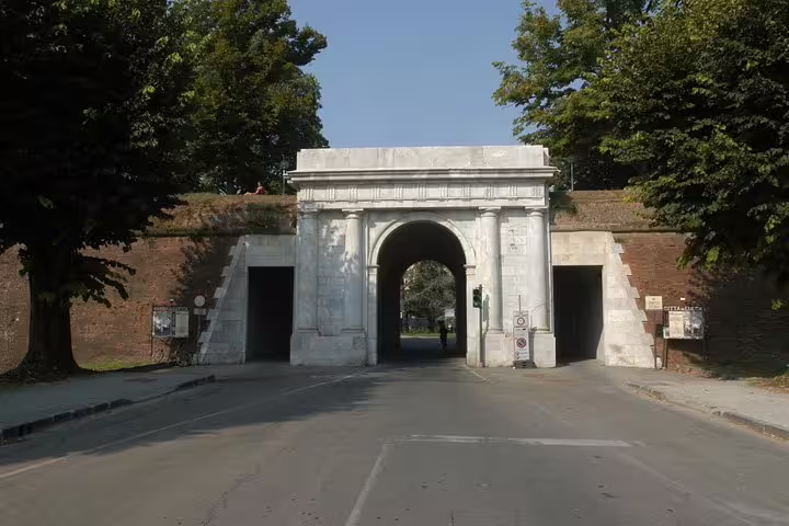 Historic stone gate in Lucca’s Renaissance city walls, entrance point for guided walking tours from Pisa day trip