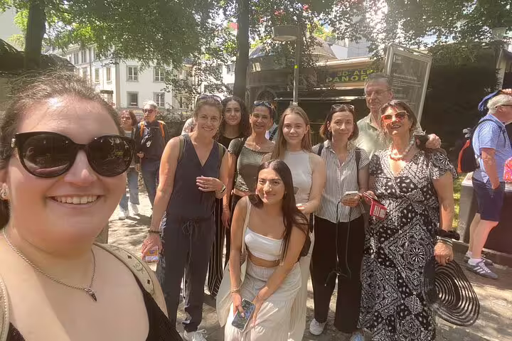 Group selfie in central Lucerne during a self-guided scavenger hunt tour, exploring top sights and landmarks