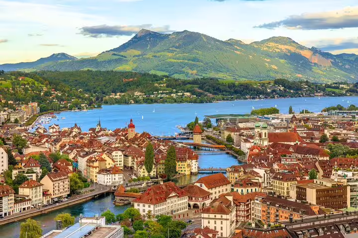 Aerial view of Lucerne, Switzerland with stunning lake and mountain backdrop, highlighting picturesque Swiss landscape.