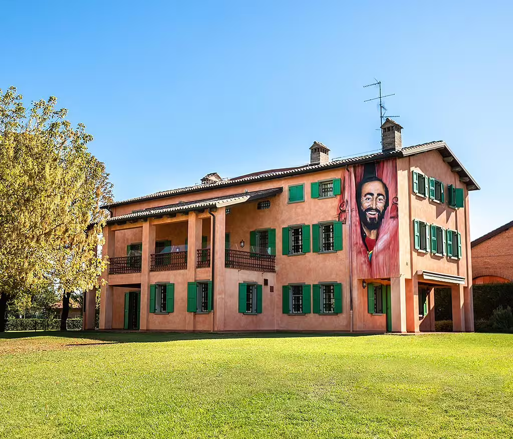 Exterior of Luciano Pavarotti House Museum in Modena with mural, included with entrance ticket tour