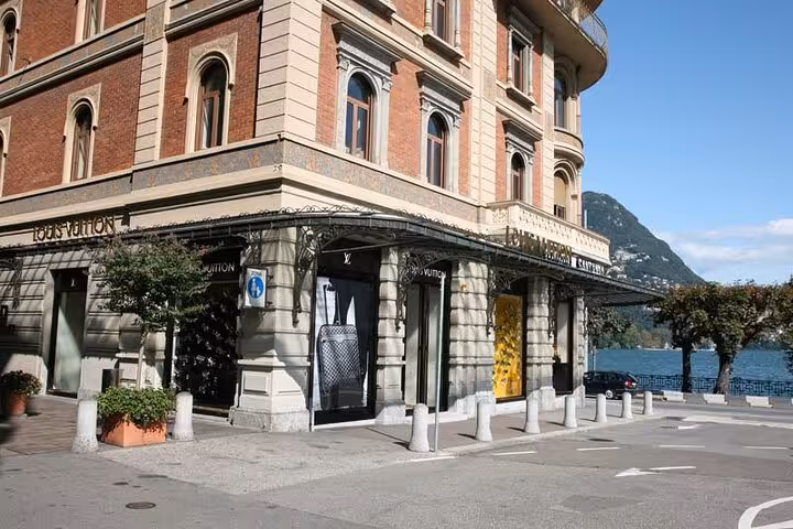 Luxury storefront on Lugano waterfront boulevard with Lake Lugano views, featured stop on Lugano city tour