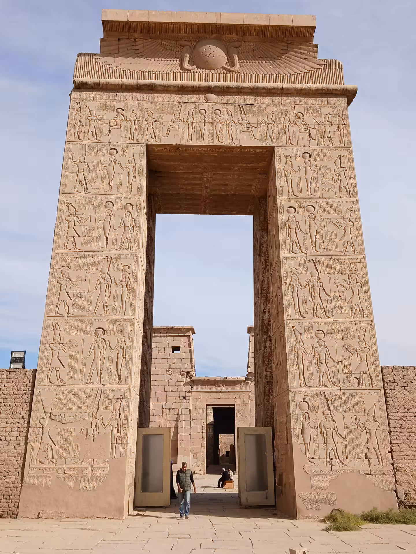 Ancient Egyptian temple gate with detailed hieroglyphics in Luxor, featured in our Luxor & Aswan multi-day tour.
