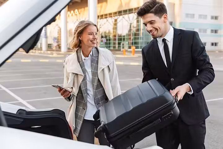 Chauffeur loading suitcase for Luxor to Aswan private transfer, stress-free door-to-door ride with meet and greet