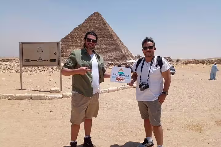 Tourists posing by the Great Pyramid of Giza on Luxor to Cairo VIP first class overnight train trip