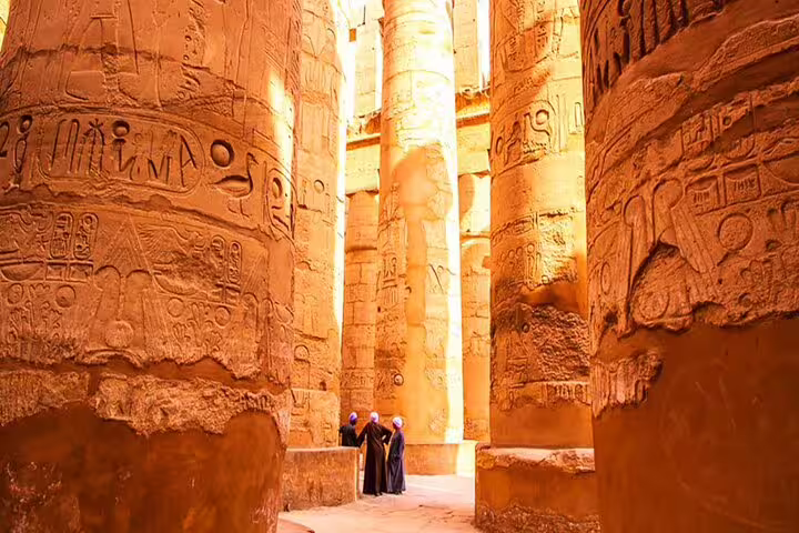Travelers explore towering carved columns at Karnak Temple on Luxor day tour from Safaga Port, Egypt