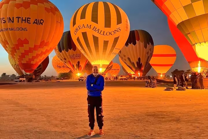 Traveler at Luxor hot air balloon launch at sunrise, part of hotel pickup and drop-off tour in Egypt
