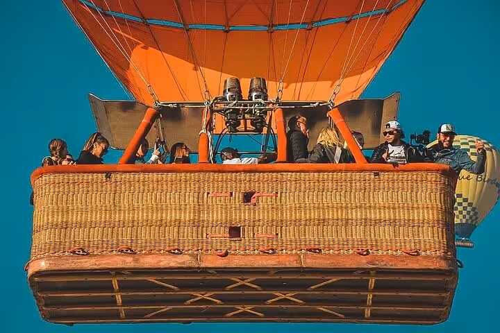 Close-up of Luxor hot air balloon basket with passengers and burners, Nile River Valley sunrise flight experience