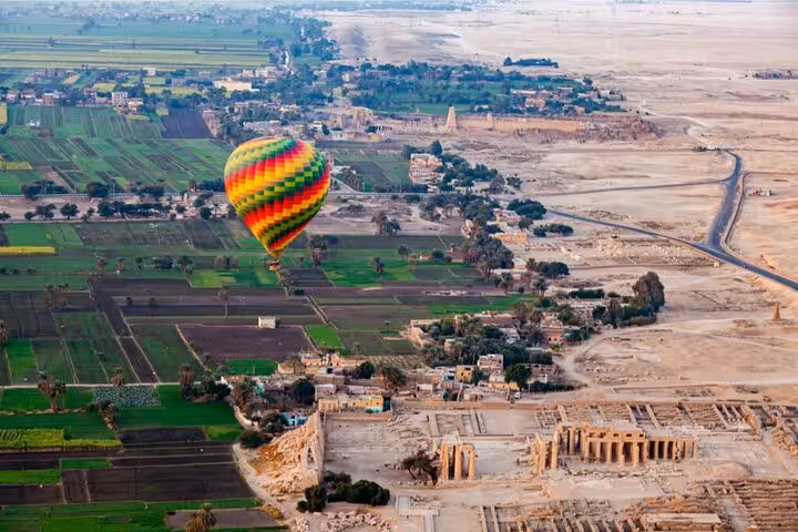 Luxor hot air balloon flight over Nile farmland and ancient temples at sunrise with hotel pickup and drop-off