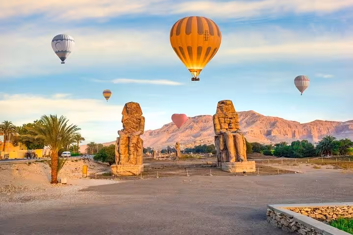 Luxor hot air balloon flight at sunrise above Colossi of Memnon, West Bank temples, with transfers
