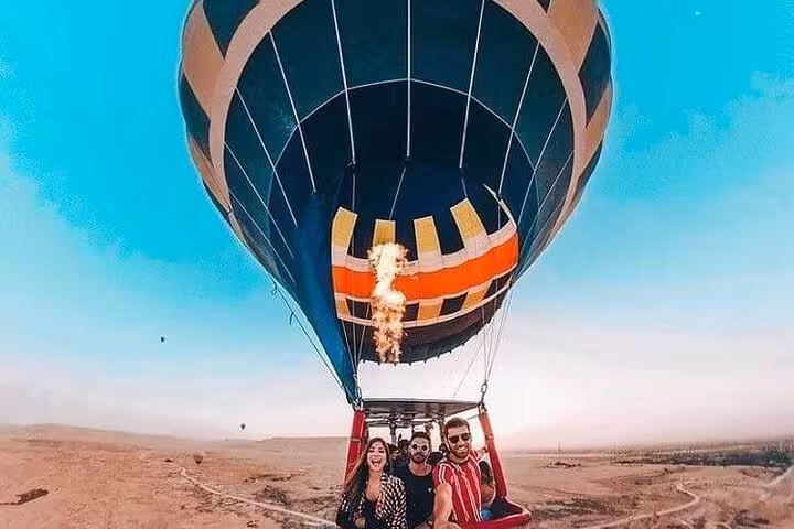 VIP hot air balloon ride in Luxor with friends in basket, flying over desert at sunrise in Egypt
