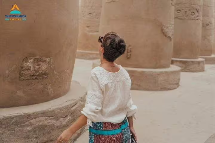 Tourist walking among Karnak Temple columns on a Luxor full day tour including Memnon and Hatshepsut