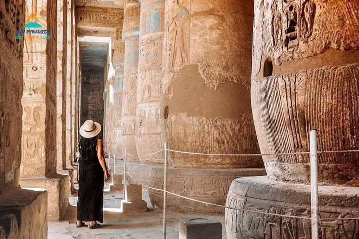 Traveler explores Karnak Temple columns and hieroglyphs on a private Luxor day tour from Cairo by air