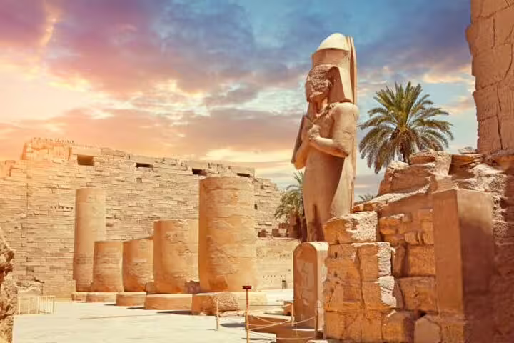 Luxor Karnak Temple statue and ancient columns at sunset, part of Karnak and Valley of the Kings day tour