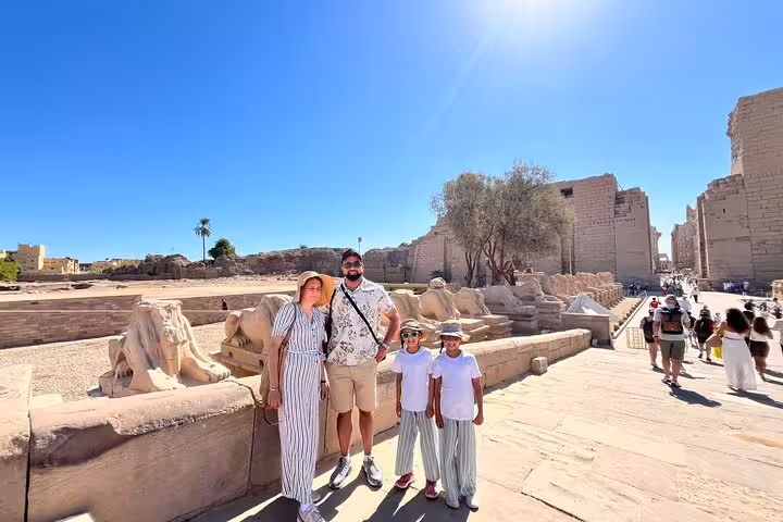Family photo at Karnak Temple avenue of sphinxes on Luxor tour from Marsa Alam with Egypt guide