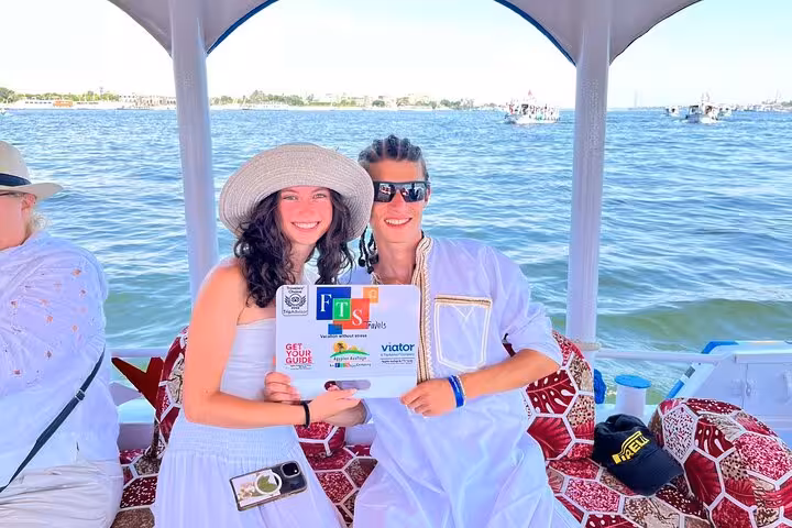 Guests on Nile felucca boat in Luxor during Marsa Alam day tour, holding travel certificates and smiles