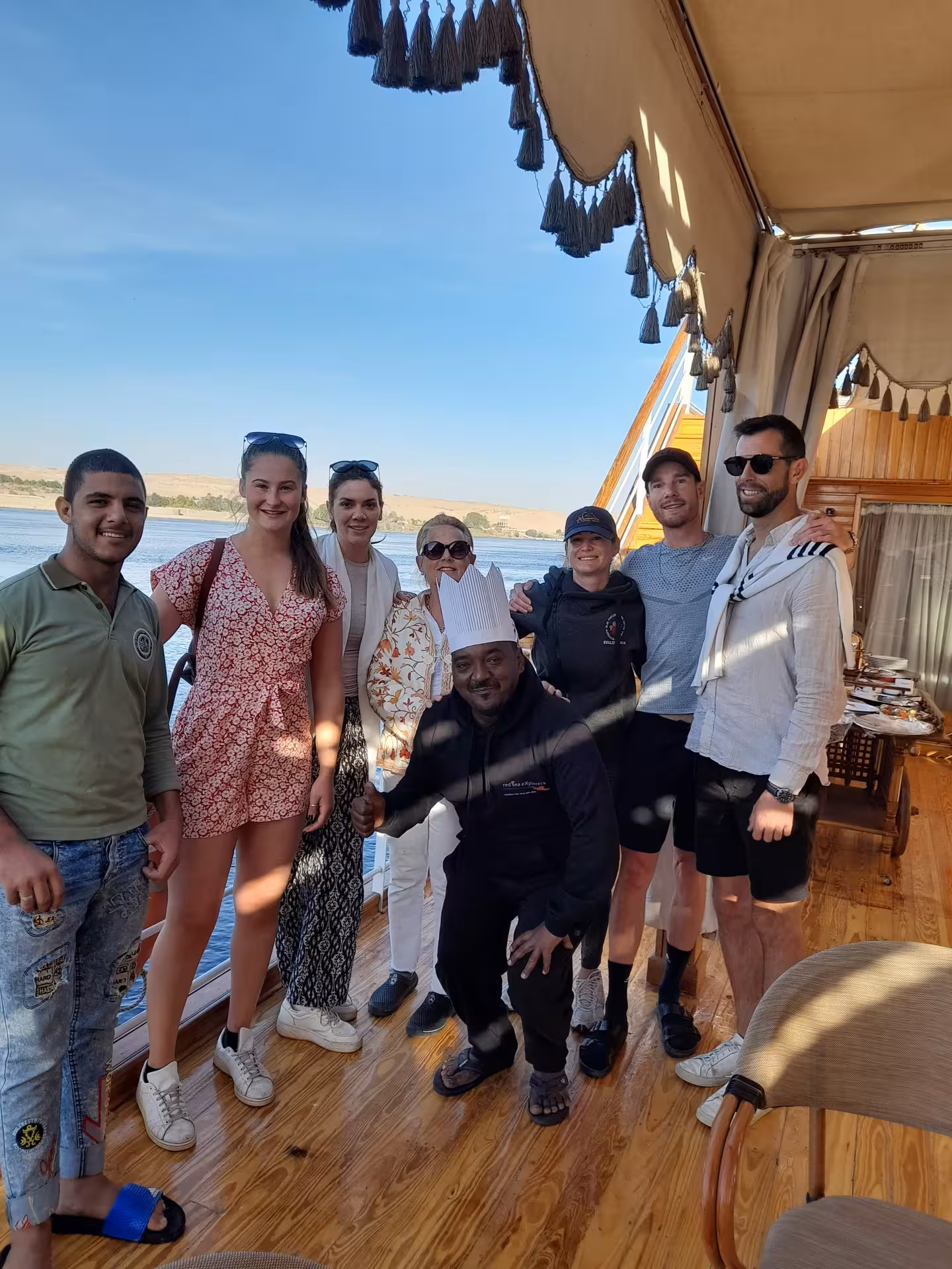 Group of tourists enjoying a sunny day on a Nile River cruise, capturing the essence of Luxor's vibrant tours.