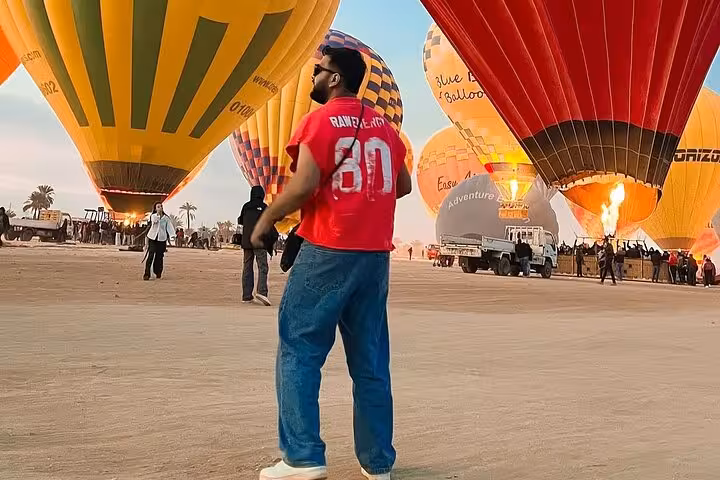 Luxor sunrise hot air balloon launch field with burners firing, ideal for hotel pickup balloon ride tour