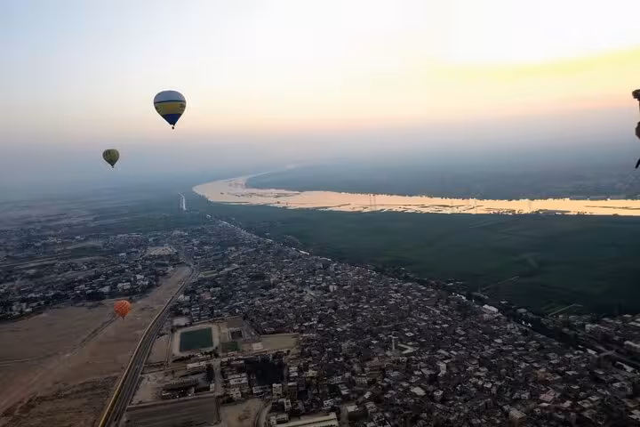 Sunrise hot air balloons over Luxor and the Nile River, aerial view on a West Bank balloon ride
