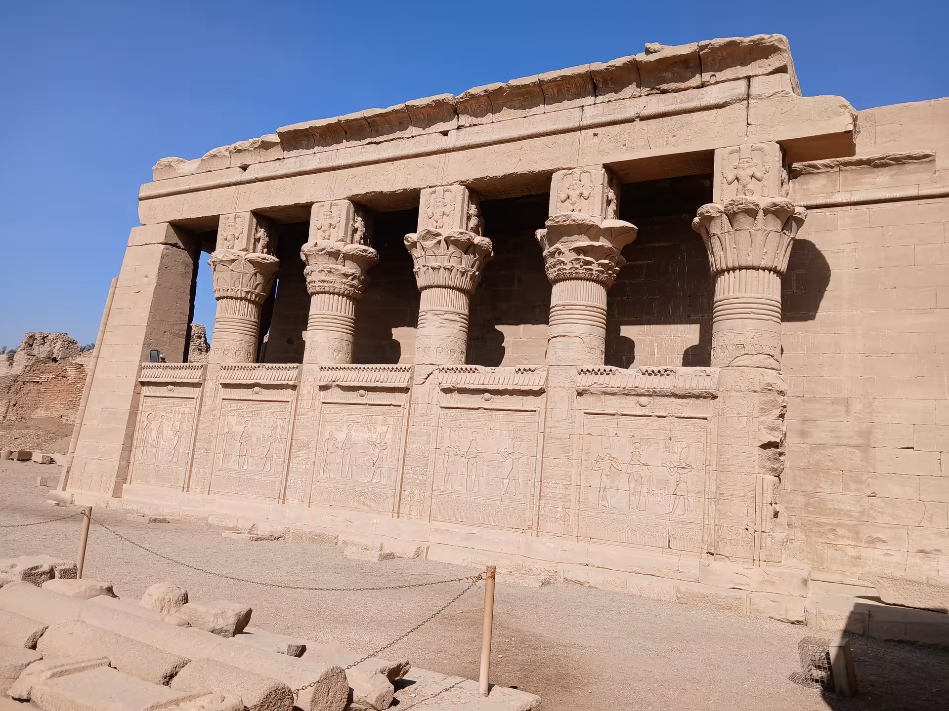 Explore the grandeur of ancient Egyptian architecture with intricately carved columns at a Luxor temple site.