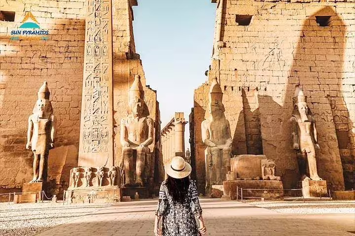 Traveler facing the towering statues and pylons of Luxor Temple on an East Bank Luxor guided tour