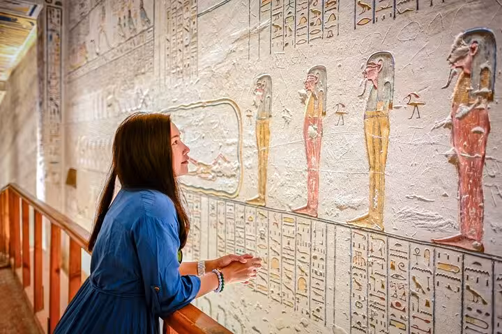 Traveler admiring ancient hieroglyphs at Luxor Temple on a 2-day Hurghada tour with hotel stay
